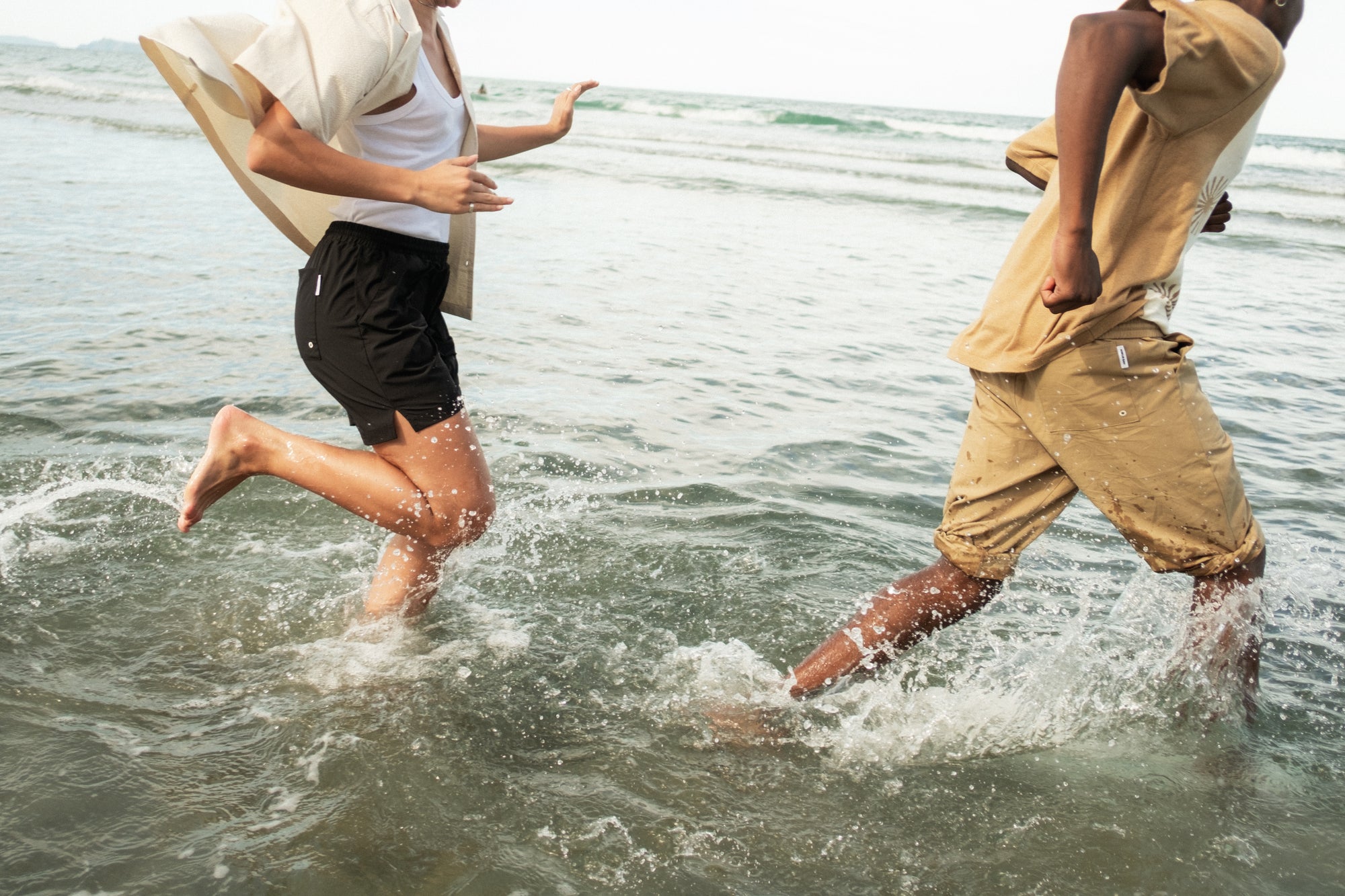 Two people running in the ocean